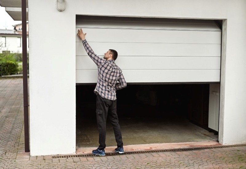 Man checking his garage door in Jacksonville, FL