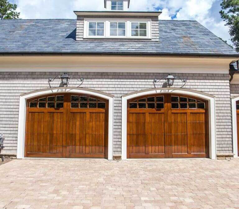 A Spacious Garage Featuring Two Wooden Doors, Ideal for Spring Repairs in Jacksonville, FL